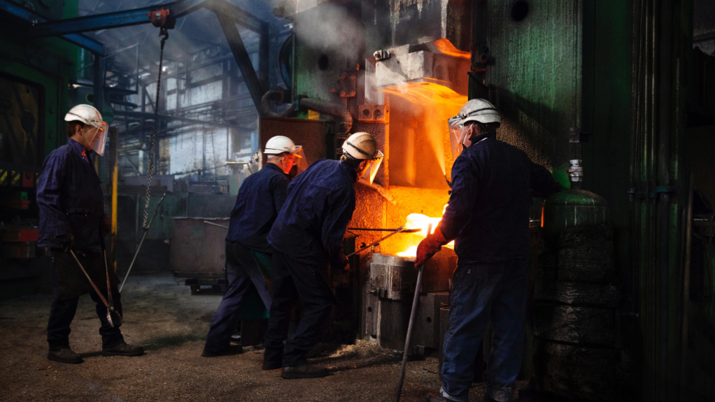 An image of steelworkers at a manufacturing plant