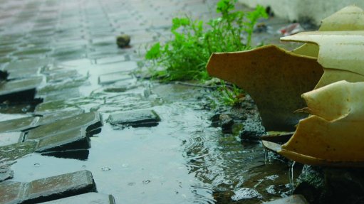 The above image depicts a broken pipe leaking water onto the ground