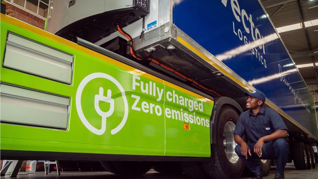 Kagiso Seune inspects the new Battery Electric Vehicle (BEV) Volvo truck with solar powered trailer’s battery pack.