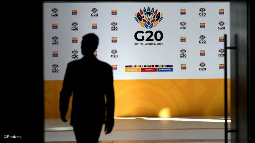 Delegate walking in front of G20 signage