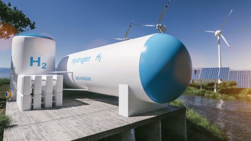 a generic image of a hydrogen tank in front of a cluster of wind turbines and solar panels