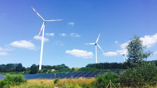 An image of solar PV panels and wind turbines 