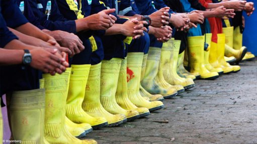 mine workers in a row with boots