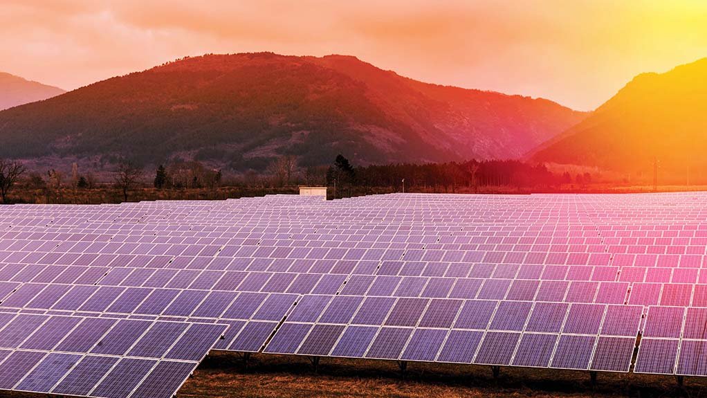 solar panels with sunset background