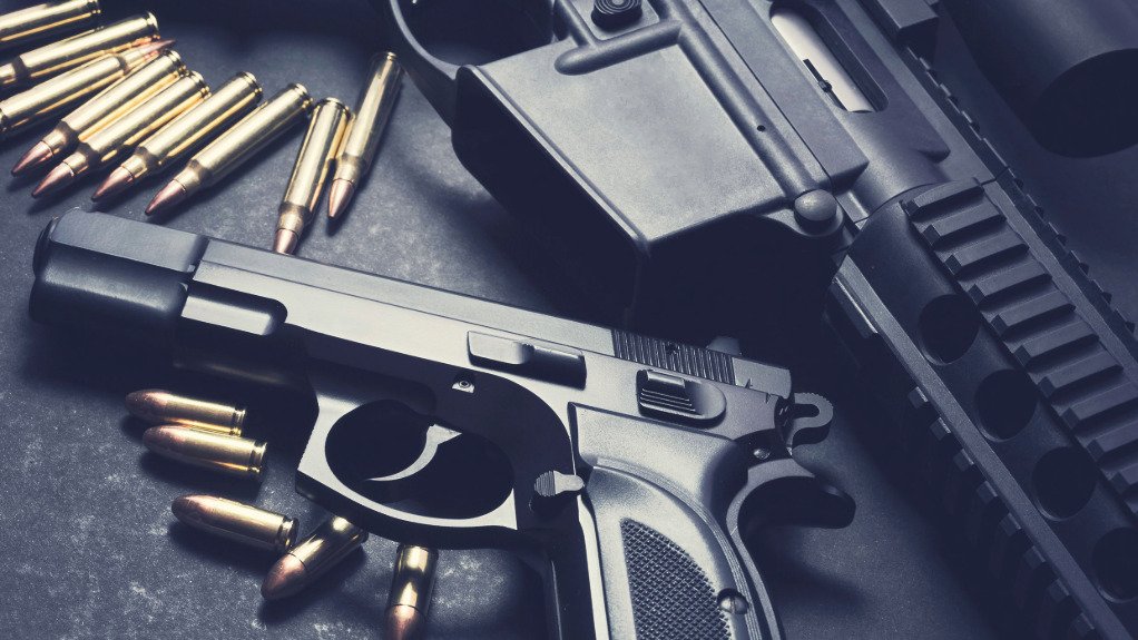 The above image depicts a hand gun and ammunition
