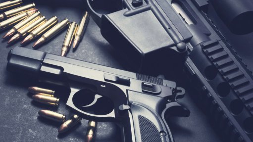 The above image depicts a hand gun and ammunition
