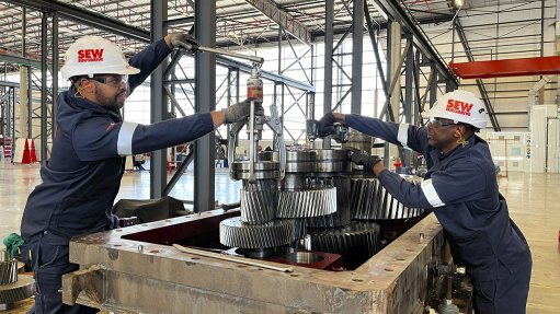 Image of SEW-EURODRIVE technicians repairing an industrial gearbox 