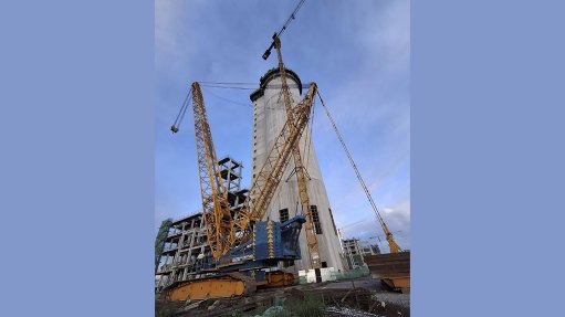 An image of a crane at the site of work