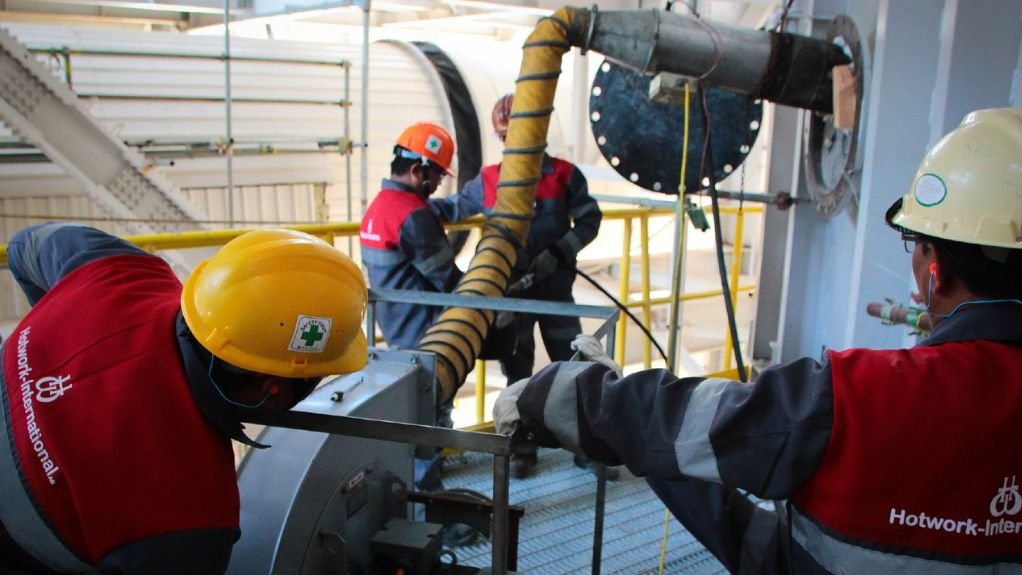 Two employees monitor the systems