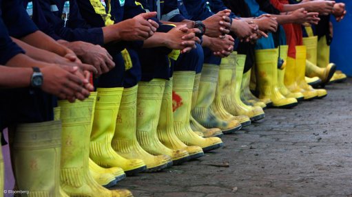 Mineworkers sitting lined up