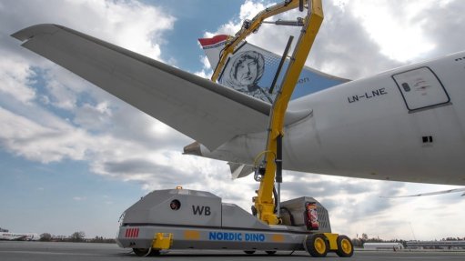 The above image depicts a technician applying a corrosion control coating to the wing of a plate 