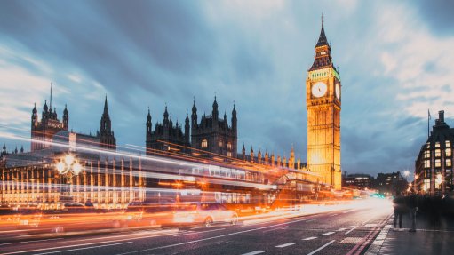 A picture of Big Ben in London at dusk with a time laps of the traffic and car lights at the fore