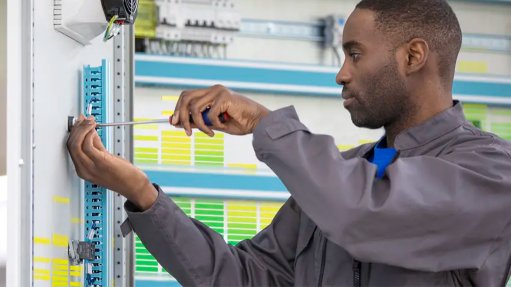 Image of a technician working on an electrical panel