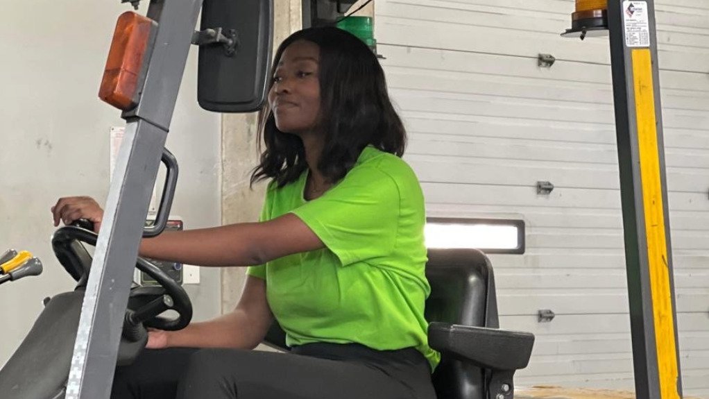 A young lady driving a forklift