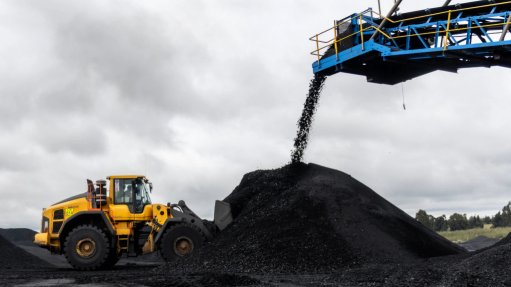 The above image depicts a wheel loader loading itself with coal 