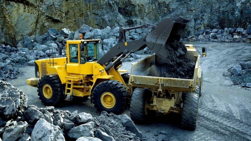 Two large yellow mining machines fitted with a weighing system on a surface mine