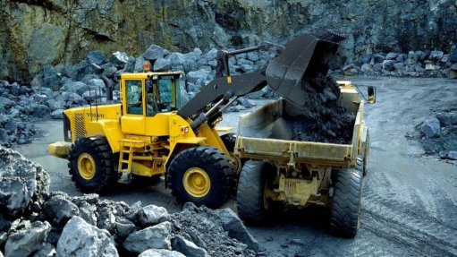Two large yellow mining machines fitted with a weighing system on a surface mine