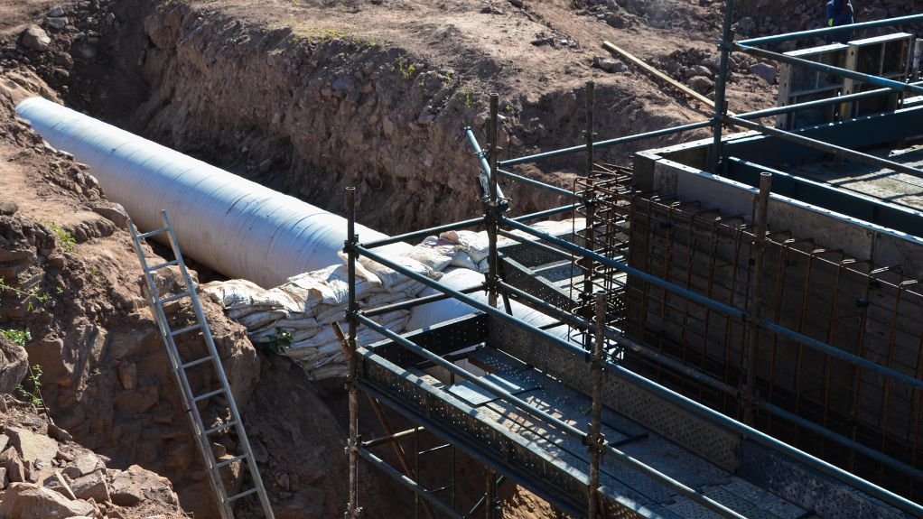 A construction site with the massive pipe.