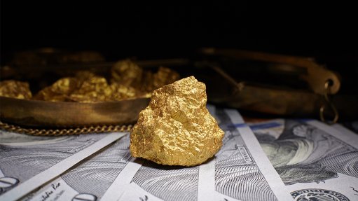 A gold nugget on dollar banknotes