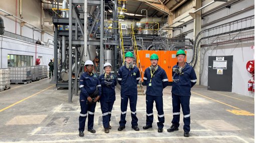 A crew of geologists stood in front of Giyani Metals' South Africa-based demonstration plant, of high purity manganese oxide