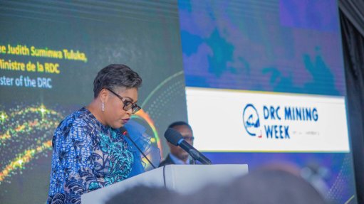 a photo of DRC's first female Prime Minister Judith Tuluka stood on the podium at DRC Mining Week