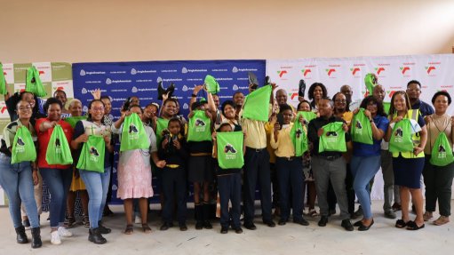 The above image depicts students of the Shoes on Feet campaign holding packets with new shoes