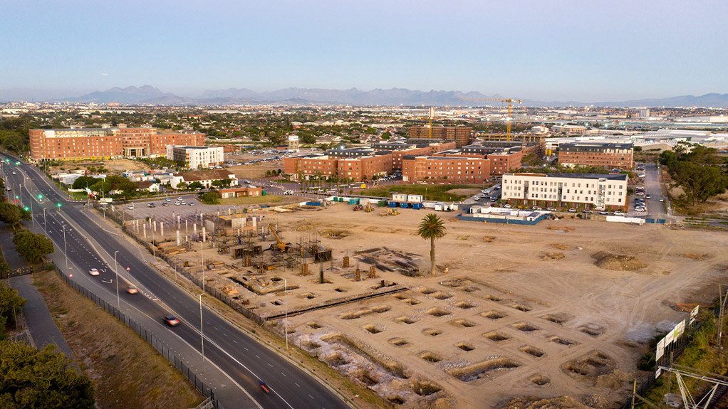 This aerial perspective of Conradie Park highlights the scale and progress of construction on The Pines retail centre within the broader precinct.