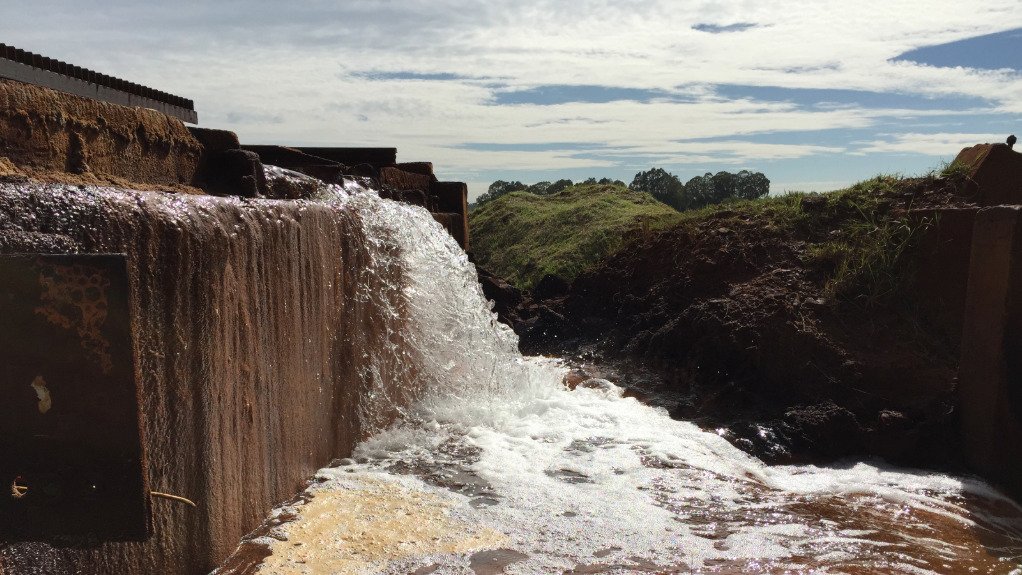 An image of water entering a river