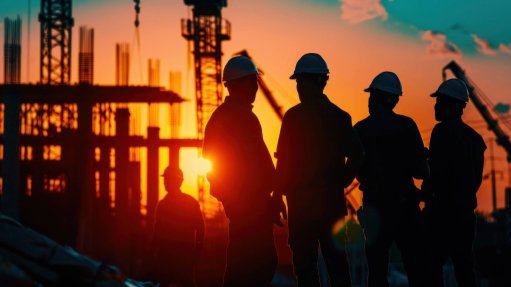 Construction workers at dawn
