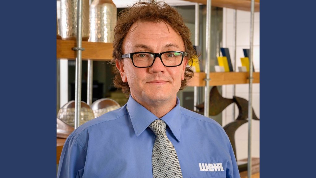Chris Mortimer in tie and blue shirt