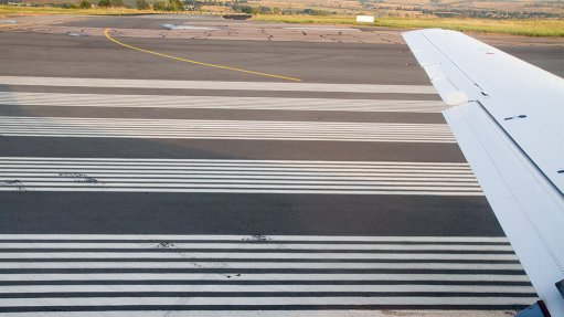 Wing of an aircraft taxiing on a runway