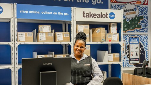 Image of a store room with boxes, a computer and an employee