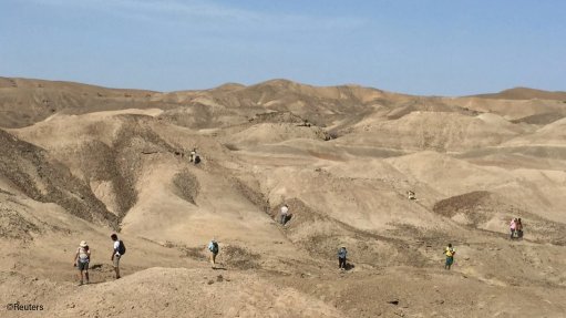 Scientists scour the landscape for fossils in the Ledi-Geraru paleoanthropological research area in the Afar Region of northeastern Ethiopia
