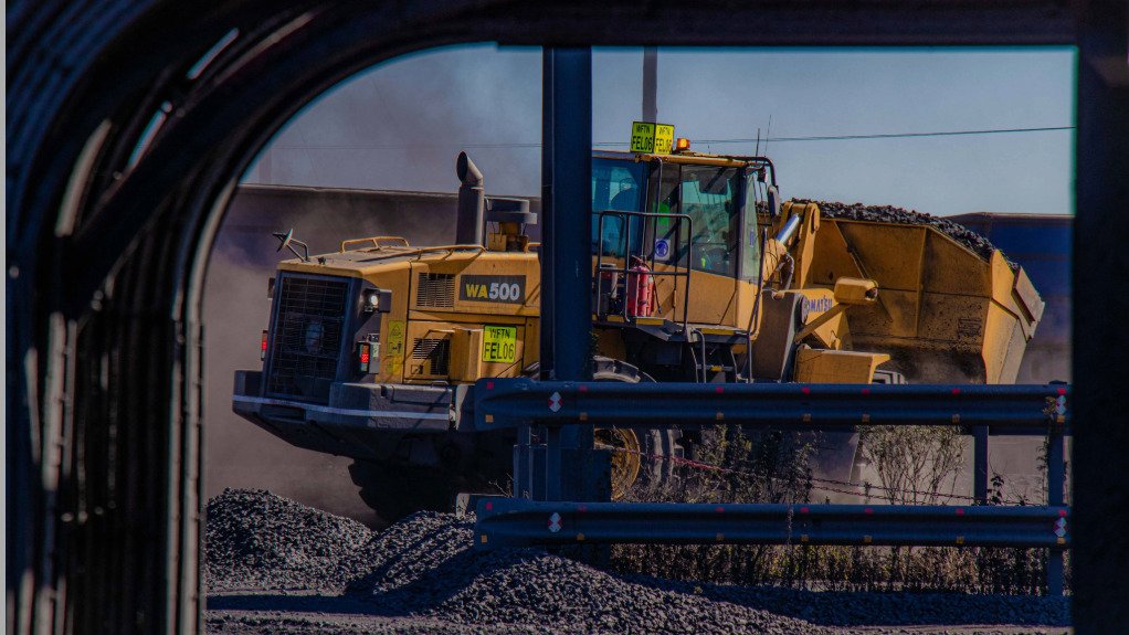 A large mine vehicle being pictured through a window