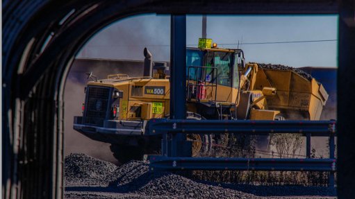 A large mine vehicle being pictured through a window
