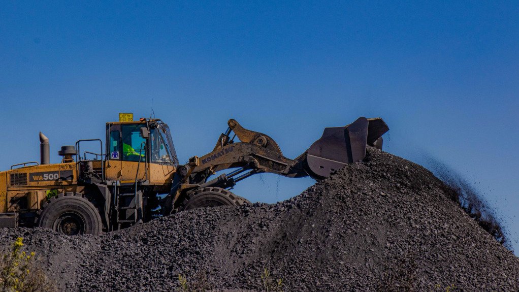 A large machine moving earth on a mine dump