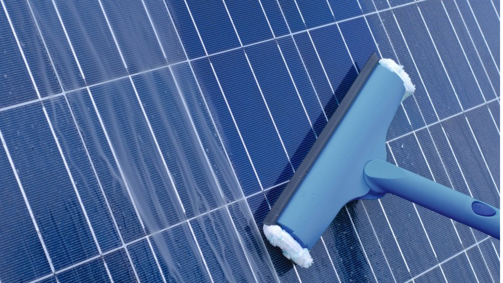 An image depicting a solar panel being cleaned