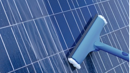 An image depicting a solar panel being cleaned