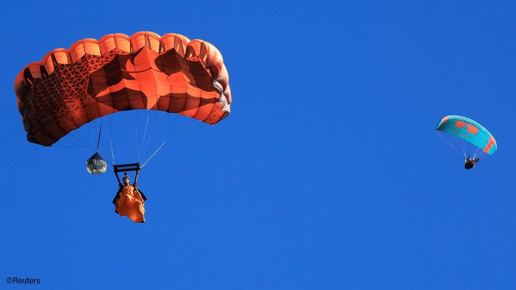 Jean-Jacques Wallis glides with a parachute after a jump from Table Mountain