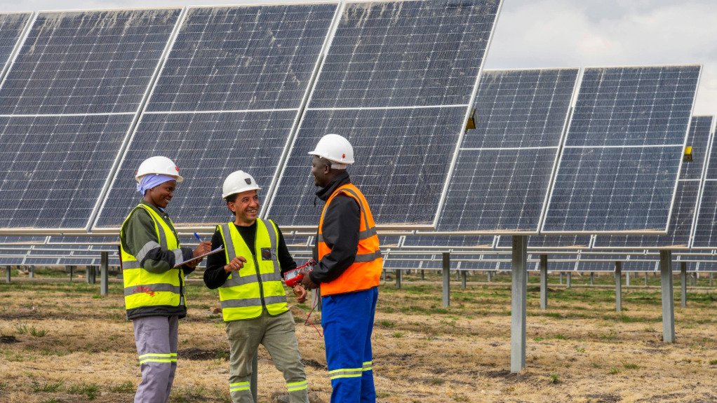 The above image depicts three technicians infront of the 35 MW solar panels