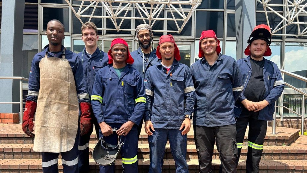 a group of young welders stood on the steps of the SAIW head office after graduating their welding courses