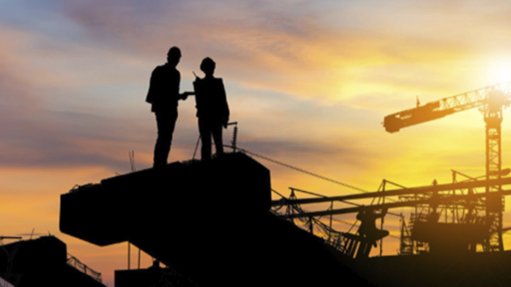 Image of silhouette of miners on a mining site