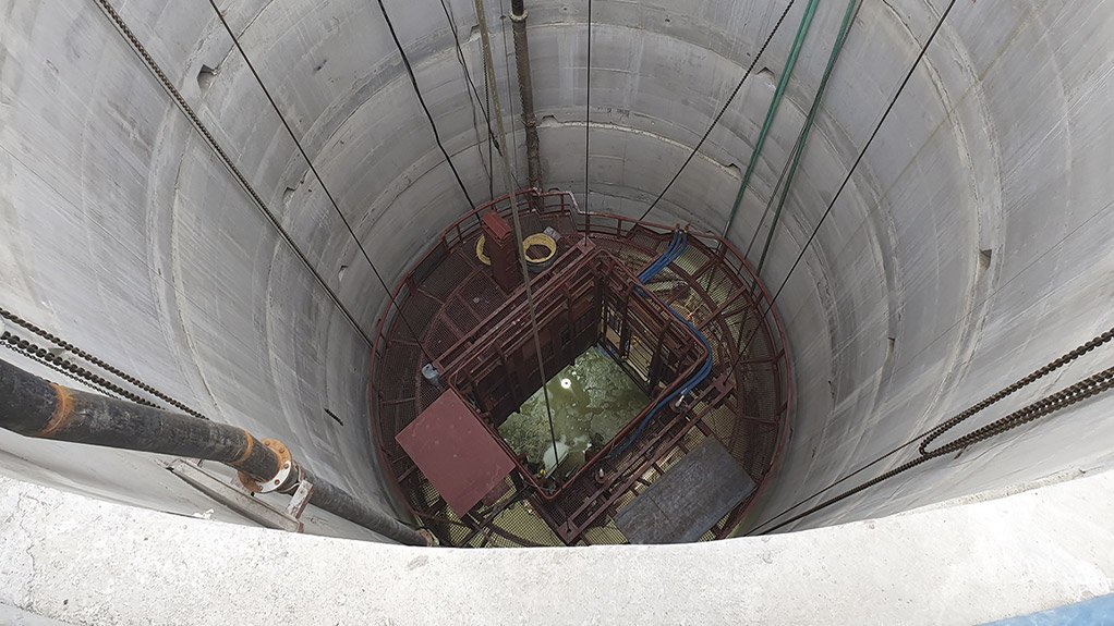 The picture shows a pre-sink stage in a concrete lined shaft with services erected