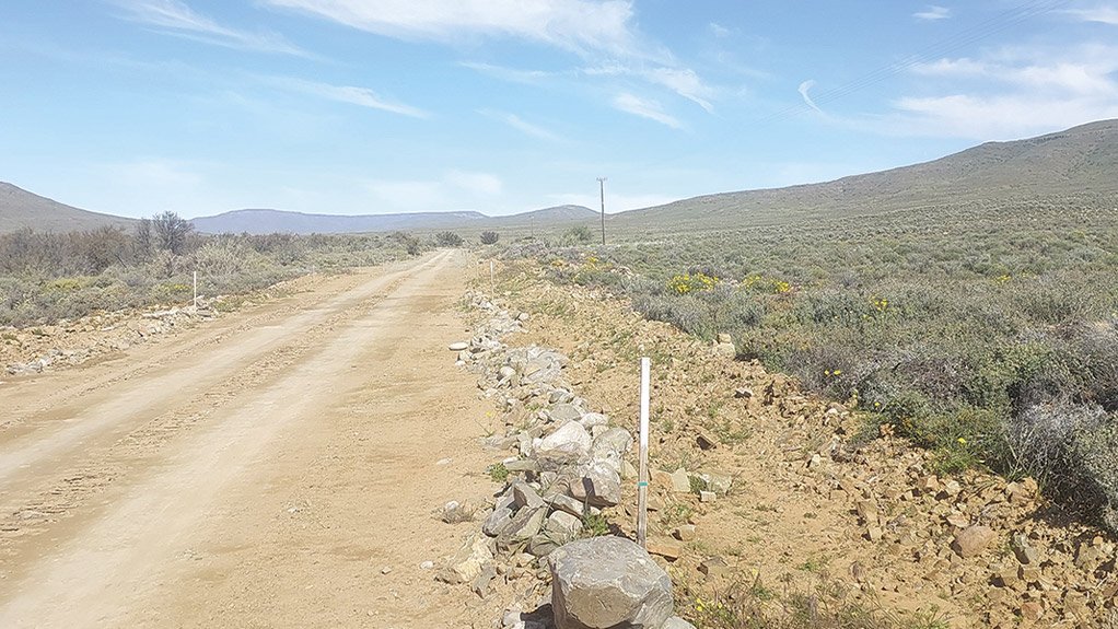 Survey poles demarcate the road servitude at the Karreebosch Wind Farm facility, reinforcing Concor’s commitment to sustainable development and environmental stewardship