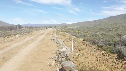 Survey poles demarcate the road servitude at the Karreebosch Wind Farm facility, reinforcing Concor’s commitment to sustainable development and environmental stewardship