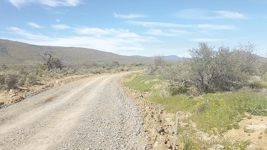 Topsoil is preserved along a road servitude at the Karreebosch Wind Farm facility, ensuring environmental care during construction