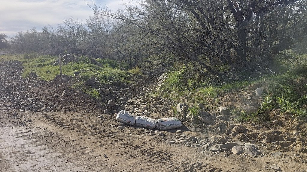A sandbag silt trap is installed at the watercourse crossing on the Karreebosch Wind Farm facility to safeguard the environment during construction