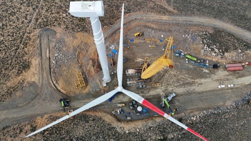 The above image depicts a wind turbine being constructed