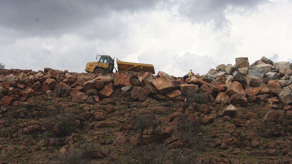 Load and haul activities taking place around a wind turbine base under construction at the De Aar 2 South Wind Energy Facility, supporting foundation works and material placement