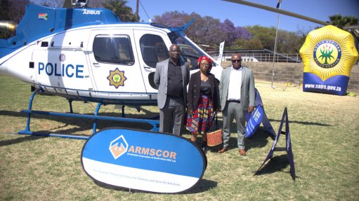 From Left: Armscor research and development group executive Dr Noel Mkaza, business development and industry executive manager Segomotso Tire and business development manager Yamkela Gungqwa with one of the helicopters handed over to the SAPS Tshwane Training Academy in Pretoria